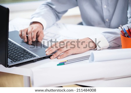 Close-up of architect working on laptop, horizontal