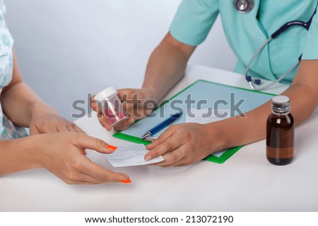 Doctor\'s hands giving prescription to patient, horizontal