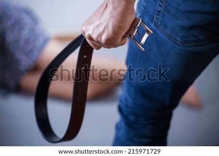 Decided, violent man with a belt, horizontal