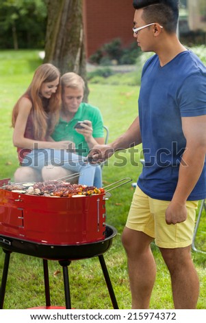 Vertical view of young friends during barbecue