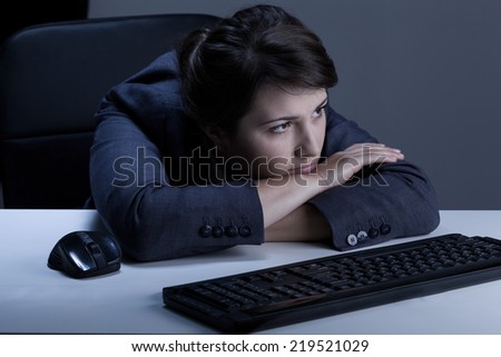 Woman is boring in the office at night