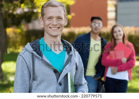 Smiling students in front of school, horizontal