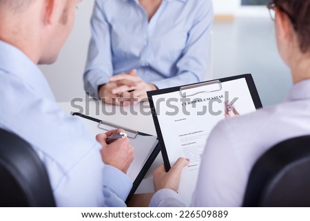 Two employers checking curriculum vitae of new candidate