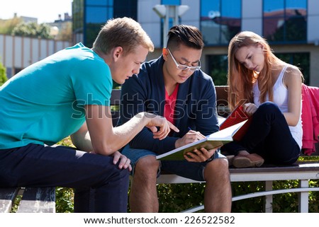 International young students learning together outside