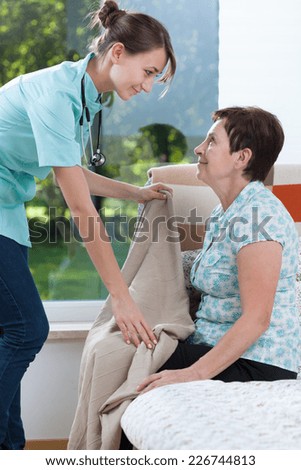 General practitioner being on home visit caring about patient