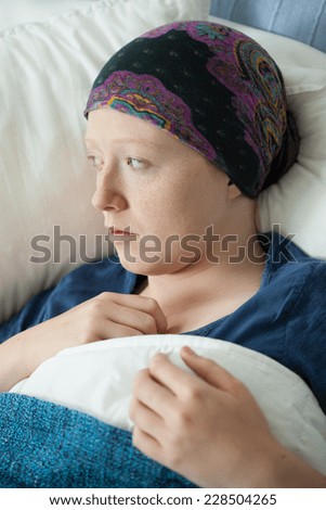Young female patient with cancer in hospital bed