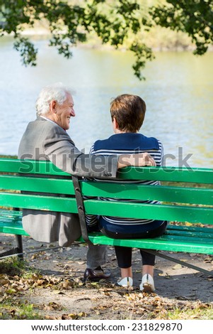 Older couple in love and autumn relax in park