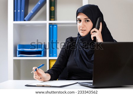 Female arab talking on phone in the office