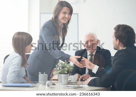 Image of businesspeople shaking hands during business meeting