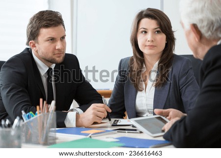 Young employees talking with boss during business appointment