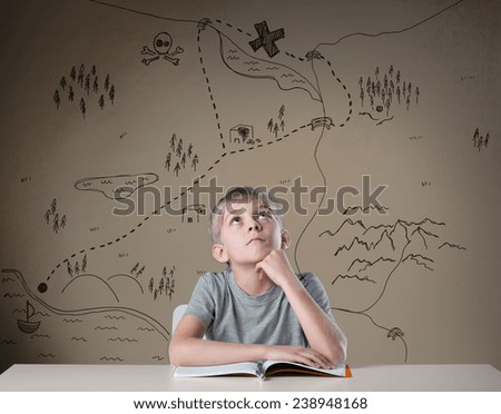 Little kid thinking about treasure map from his adventure book
