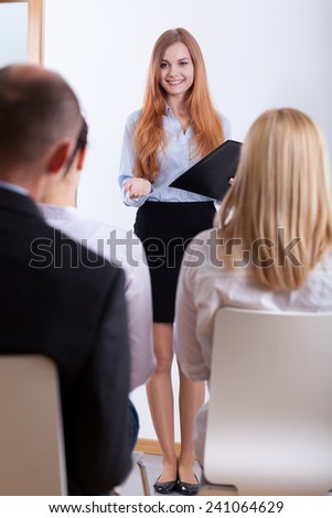 Smiling girl showing herself on a job interview