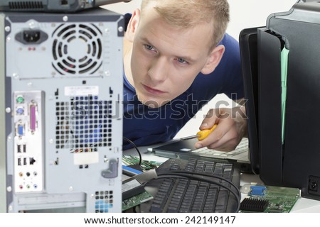 Young attractive computer science looking at damaged computer