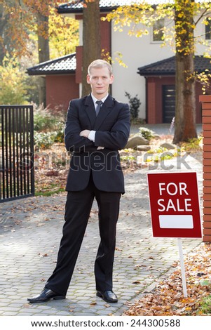 Young attractive real estate broker selling the house
