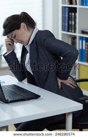 Woman with sedentary lifestyle having pain in lumbar spine