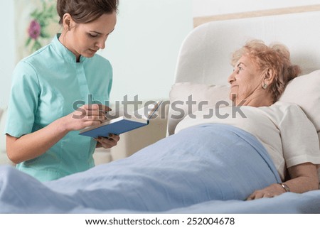 Close-up of caregiver reading ill patient book
