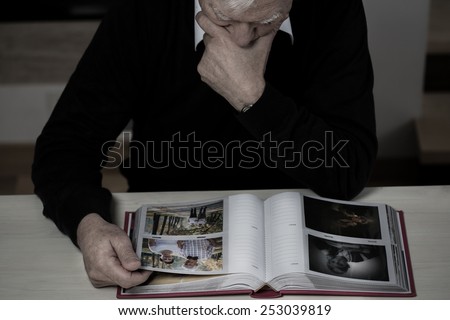 Lonely elderly man recollect happy memories from his life