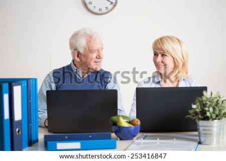 Elderly busy couple running together a business