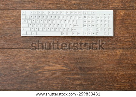 Close-up of white keyboard on wooden table