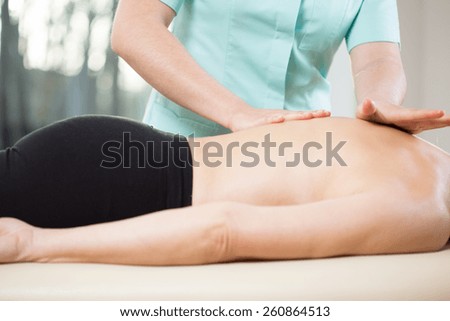 Physiotherapist doing medical massage to relieve back pain