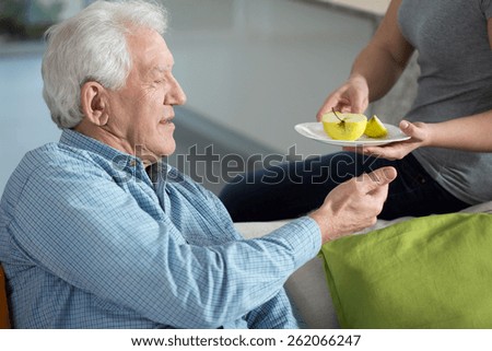 Close-up of daughter caring about senior father