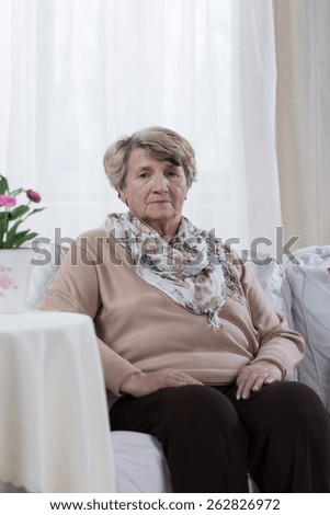 Sad elder woman being alone at home
