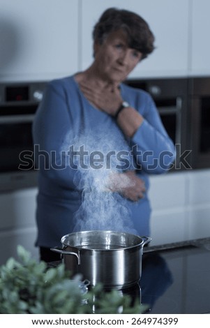 Image of retired woman having pain in chest