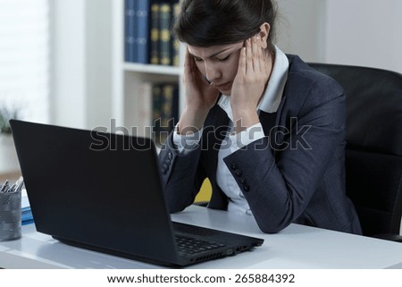 Female overworked manager having headache at work