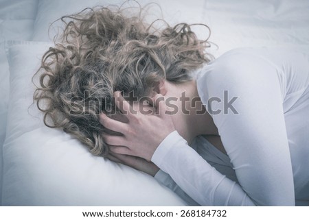 Close-up of young woman in despair covering her face