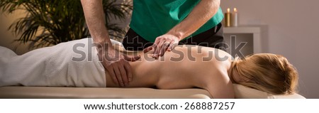 Young attractive woman lying on massage table