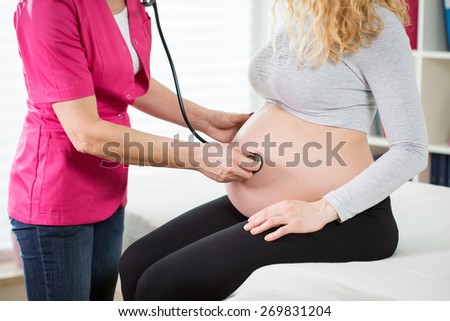 View of examination during pregnancy with stethoscope