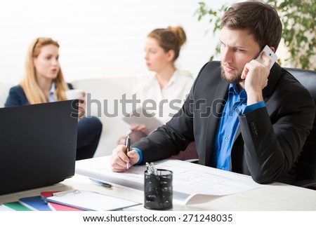 Worried and busy businessman and his team in office