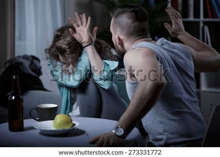 Yelling aggressive man beating his scared wife