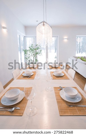Photo of elegant table setting on white wooden table