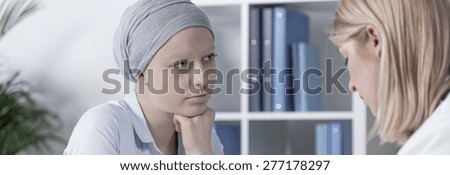 Cancer woman wearing scarf during medical consultation