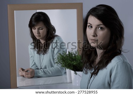 Depressed lonely woman repressing her real emotions