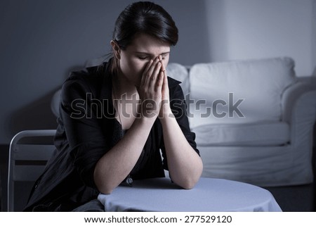 Despair divorced woman sitting at the table and crying