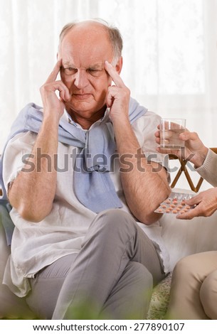 Ill retired man having pain in temples