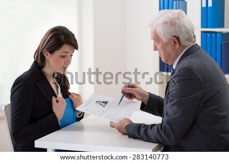 Young woman talking with an older man about a potential job
