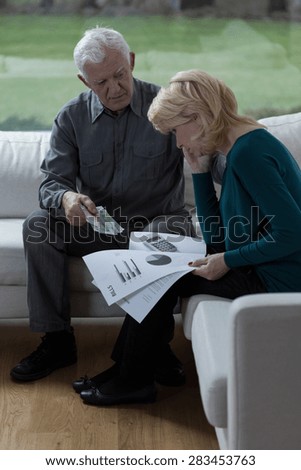 Old marriage talking about bills and their financial situation