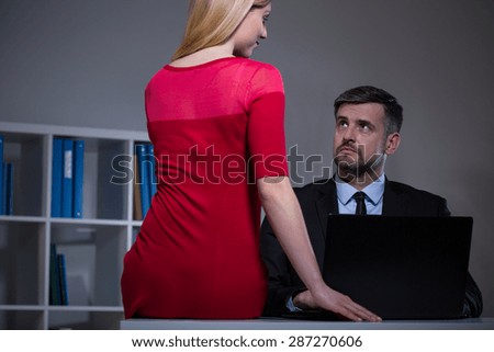 Attractive secretary seducing her boss in office