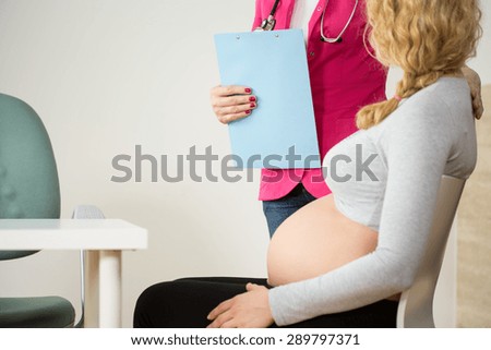 Woman during pregnancy having control visit at doctor\'s office