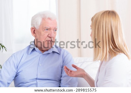 Older nice man and young pretty nurse at home