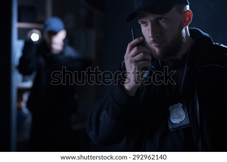 Photo of an policeman calling for back up on radio