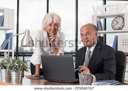 Photo of happy smiling elders in the office