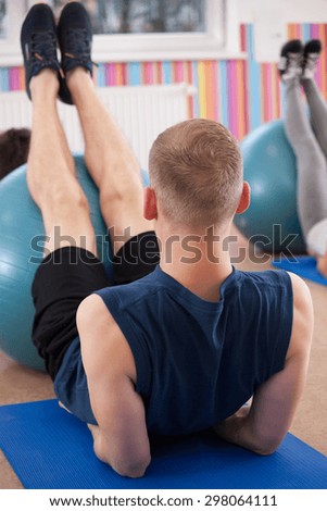 Man during pilates training on foam mattress