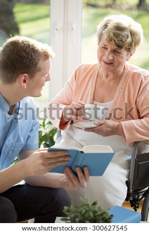 Young man with older woman spending time at home