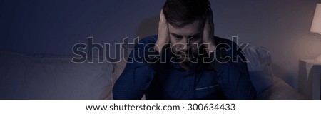 Portrait of despair mature man covering ears