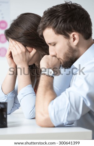 Crying married couple sitting at doctor\'s office