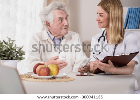 Young female doctor visiting patient at home
